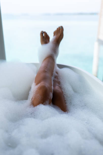 istock Unrecognizable woman relaxing in bubble bath. 1192648892