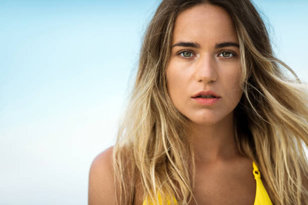 Portrait of beautiful woman in summer day looking at camera.