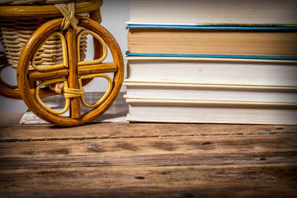 istock A stack of books and a wicker willow product on a wooden table 1192649279