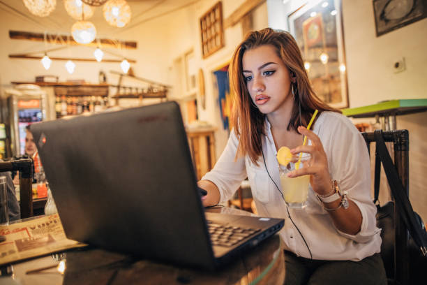 istock Beautiful young woman is using laptop 1192651122