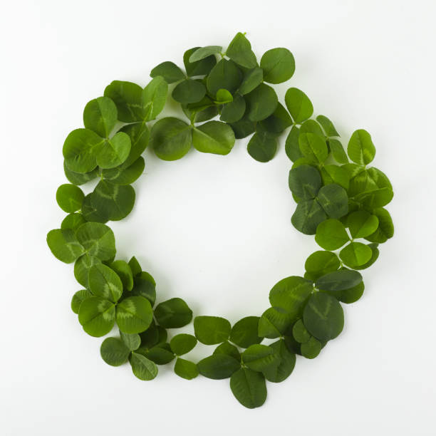 istock Green clover shamrock leafs wreath border frame on white background. St. Patrick's Day postcard template. 1192651137