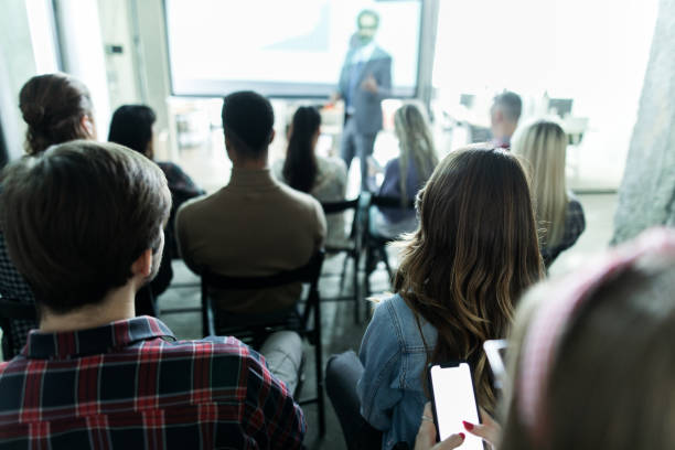 istock Back view of creative people on education event in the office. 1192651334