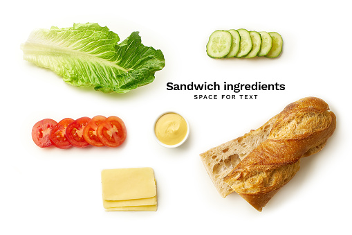 Flatlay with vegetarian sandwich ingredients isolated on white background: baguette, cheese, salad, veggie slices and mustard sauce.