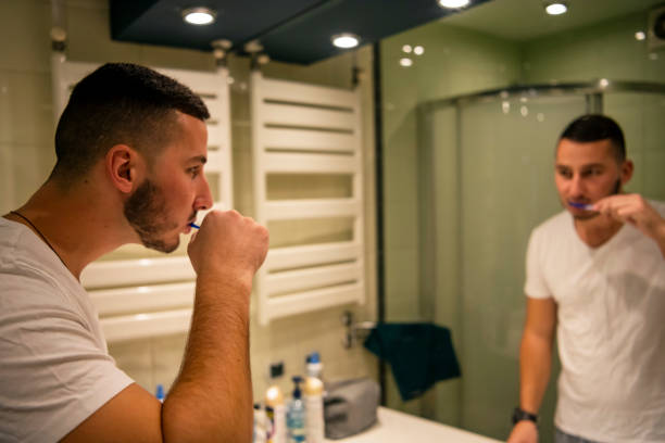 istock Man is Brushing Teeth in the Bathroom 1192651513