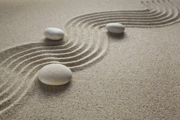 istock zen garden stones in light sand for relaxation and concentration during meditation 1192652547