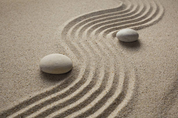 istock zen garden stones in light sand for relaxation and concentration during meditation 1192652646