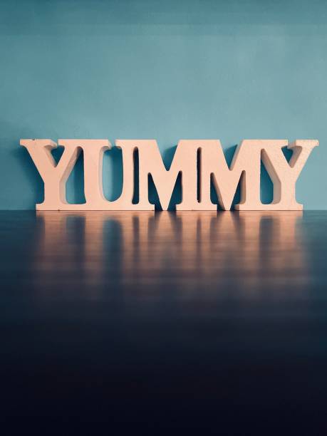 istock Word YUMMY on blue background 1192655026