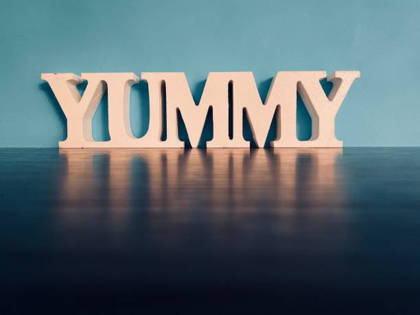istock Word YUMMY on blue background 1192655032