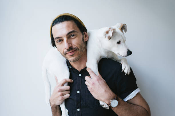 istock Studio portrait of a handsome guy holding his dog 1192658906