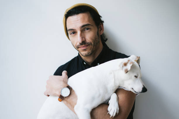 istock Studio portrait of a handsome guy holding his dog 1192658911