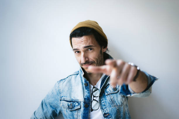 Portrait of a handsome guy pointing his finger at you