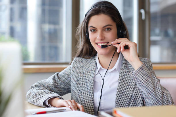 istock Woman customer support operator with headset and smiling. 1192659766