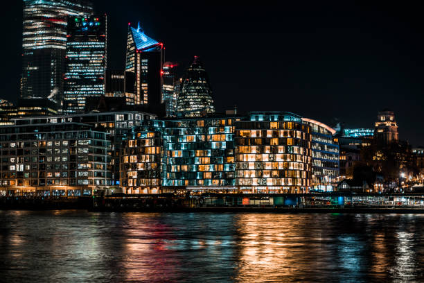istock Londons modern skyline at night over looking the river Thames 1192660120
