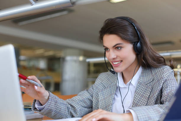 istock Woman customer support operator with headset and smiling. 1192660166