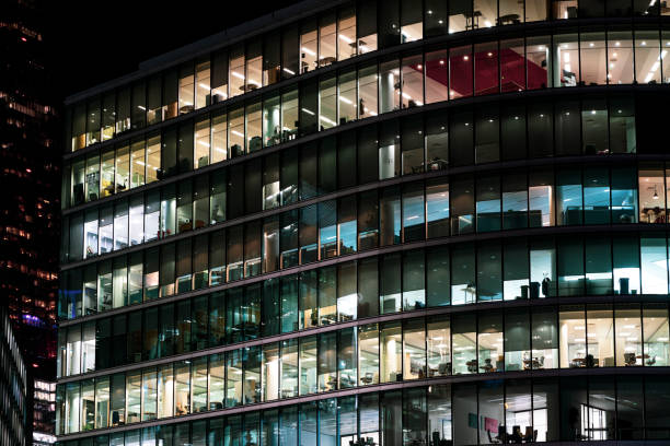 istock Modern offices in a large glass fronted building at night 1192660959