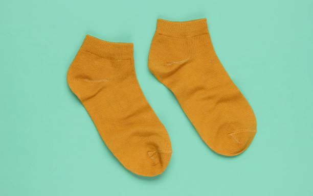 istock Orange socks on blue background. Top view 1192661053