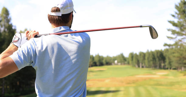 istock Athletic young man playing golf in golf club. 1192661103
