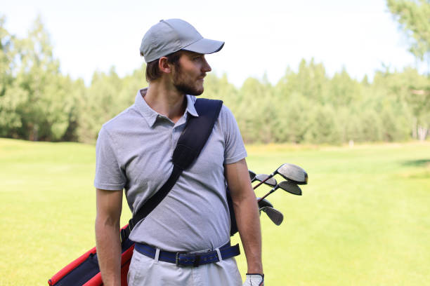 istock Golf player walking and carrying bag on course during summer game golfing. 1192661147