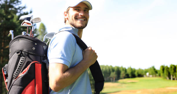 istock Golf player walking and carrying bag on course during summer game golfing. 1192661192