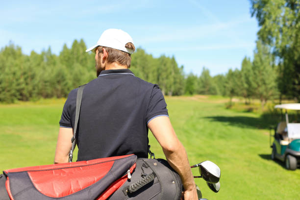 istock Golf player walking and carrying bag on course during summer game golfing. 1192661210