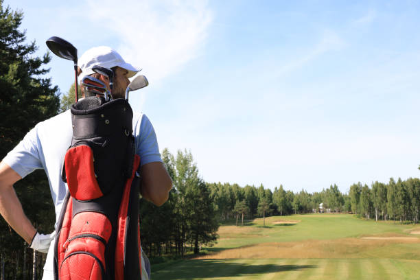 istock Golf player walking and carrying bag on course during summer game golfing. 1192661434