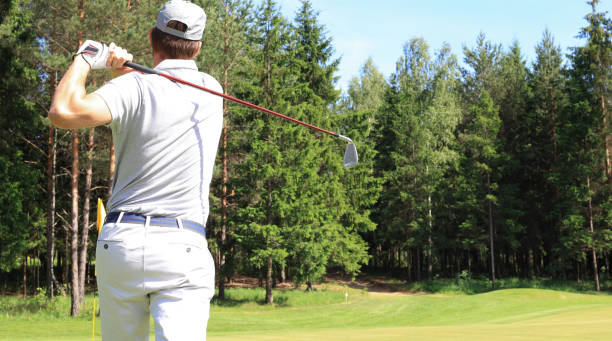 istock Athletic young man playing golf in golf club. 1192661591
