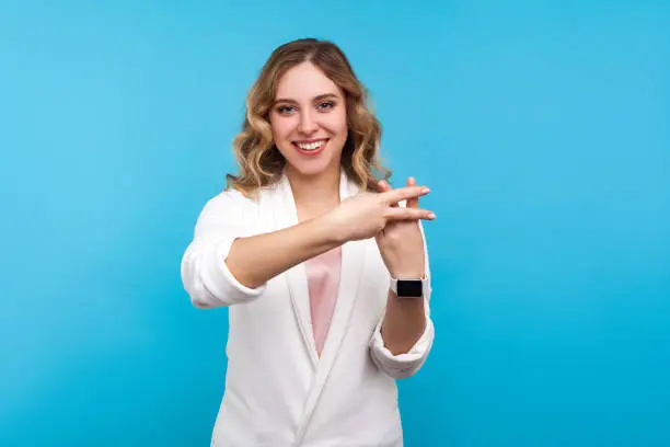 Photo of Hash symbol. Portrait of bright trendy attractive woman making hashtag gesture and smiling. blue background