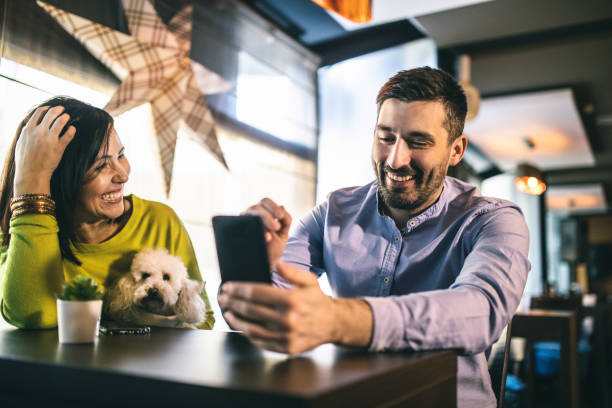 istock Friends relaxing around a table at a coffee shop 1192662772