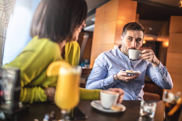 istock Friends relaxing around a table at a coffee shop 1192662861