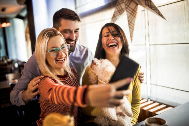 istock Friends relaxing around a table at a coffee shop 1192664393
