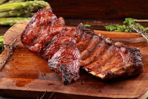 istock Marinated Grilled Baby Back Ribs on wooden platter 1192665215