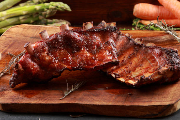 istock Marinated Grilled Baby Back Ribs on wooden platter 1192665218