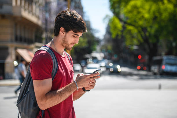 istock Hispanic Male Backpacker Checking Directions on Smart Phone 1192666354