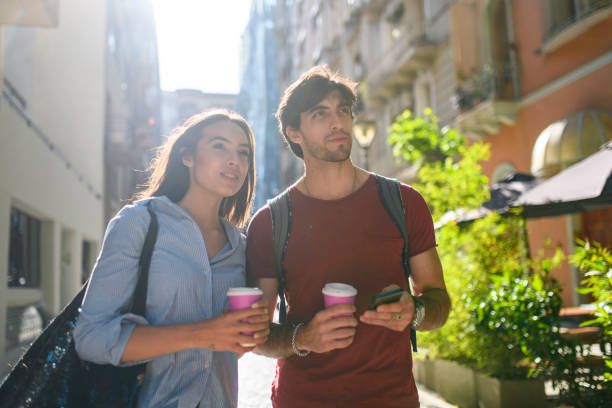 istock Tourists with Coffee Checking Directions on Smart Phone 1192666366