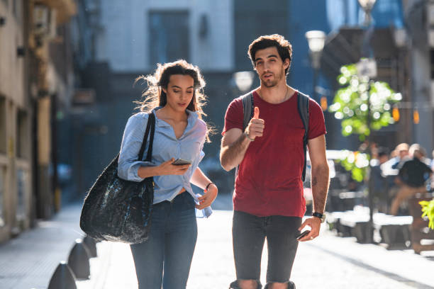 istock Young Hispanic Vacationers Using Smart Phone for Directions 1192666371