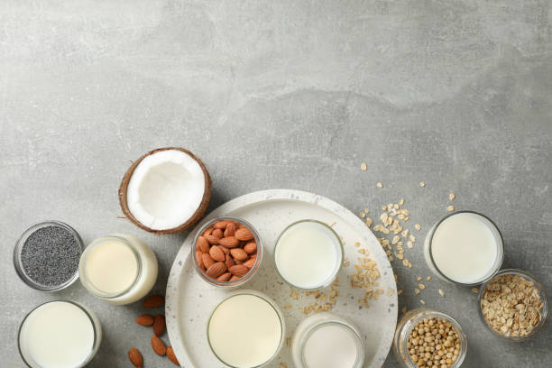 istock Bottle and glass of different types milk on grey background, space for text. Top view 1192666556