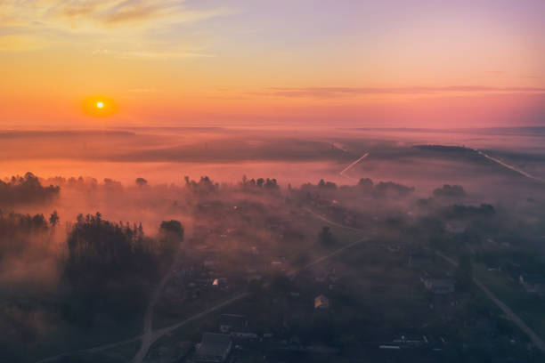 istock Summer sunrise in the fields and forest with fog 1192666752