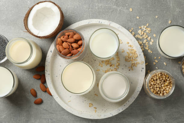istock Bottle and glass of different types milk on grey background, space for text. Top view 1192666766