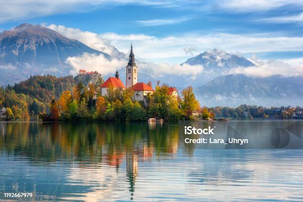 Famous Alpine Bled Lake In Slovenia Amazing Autumn Landscape Scenic View Of The Lake Island With Church Bled Castle Mountains And Blue Sky Stock Photo - Download Image Now