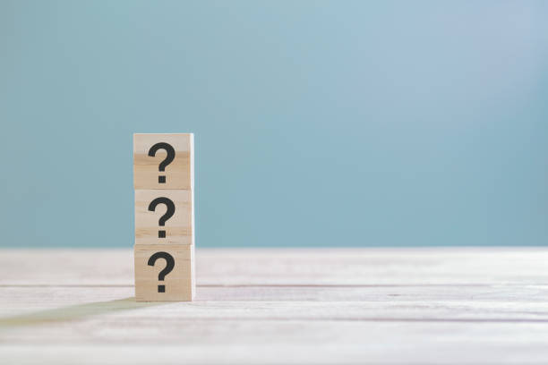 istock Wooden cube block with sign question mark symbol on wood table with with copy space 1192669920
