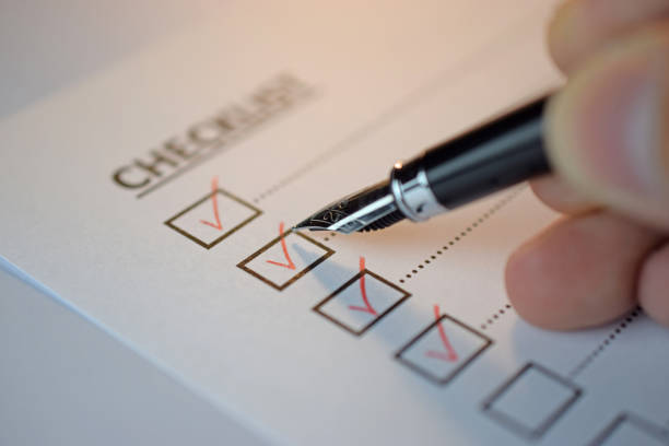 istock Checklist concept - checklist box with red checkmark, paper and a pen with checklist word on table 1192670012