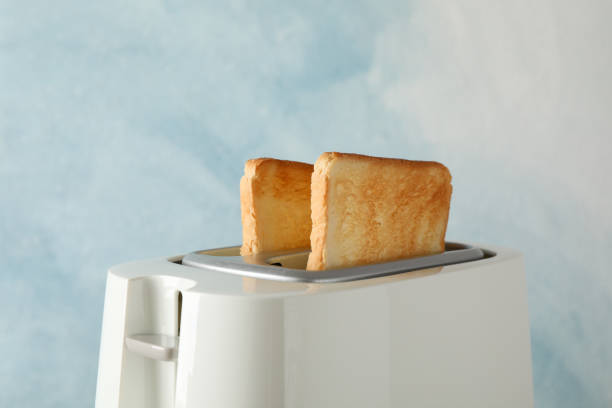 istock Toaster with bread slices on blue background, space for text 1192670205