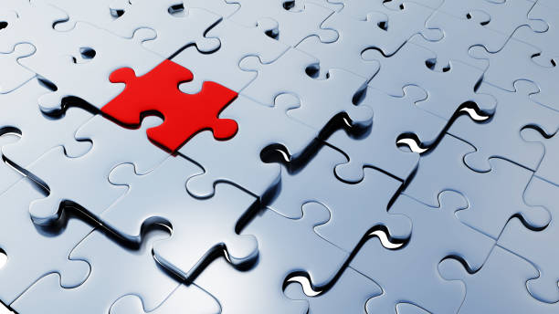 istock Many silver puzzle pieces almost in place with one large red piece between them 1192671102