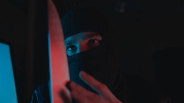 istock A thief with mask holding a knife threaten someone. Thief concept 1192671298