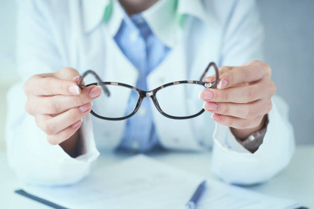 istock Optician giving new glasses to customer for testing and trying. 1192671532