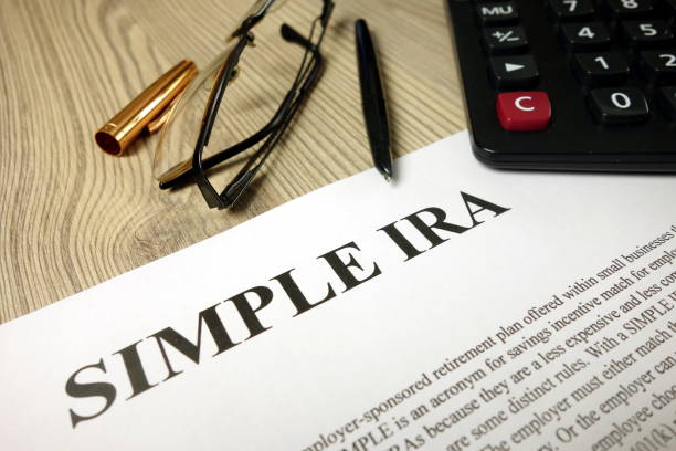istock Simple ira document with pen calculator and glasses 1192671668