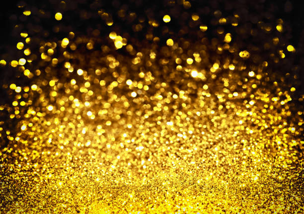 istock golden glitter bokeh lighting texture Blurred abstract background for birthday, anniversary, wedding, new year eve or Christmas 1192674959
