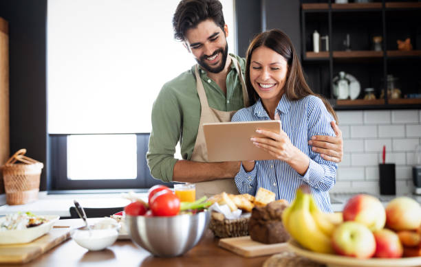 istock Beautiful couple in the kitchen while cooking. 1192676419