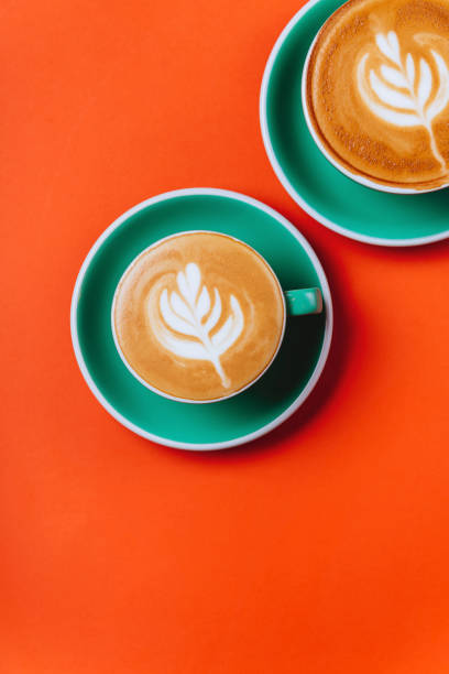 istock Cyan coffee cups over orange background. 1192677373