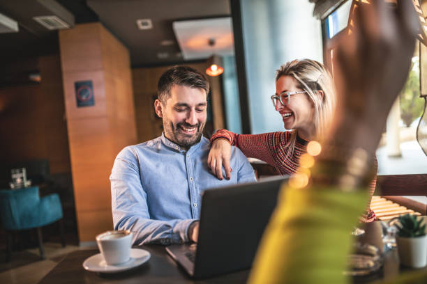 istock Friends relaxing around a table at a coffee shop 1192677540